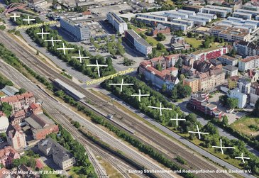 Der Frankenschnellweg zwischen Gostenhof und St. Leonhard aus der Vogelperspektive von Nordosten aus. An dieser Stelle gabelt sich der FSW in zwei Fahrrichtungen, dazwischen ein relativ großes Wäldchen auf dem Gebiet des ehemaligen Hafenbeckens des Ludwigskanals. Dieses Wäldchen ist als Rodungsfläche für den Eingang des geplanten Tunnels gekennzeichnet.